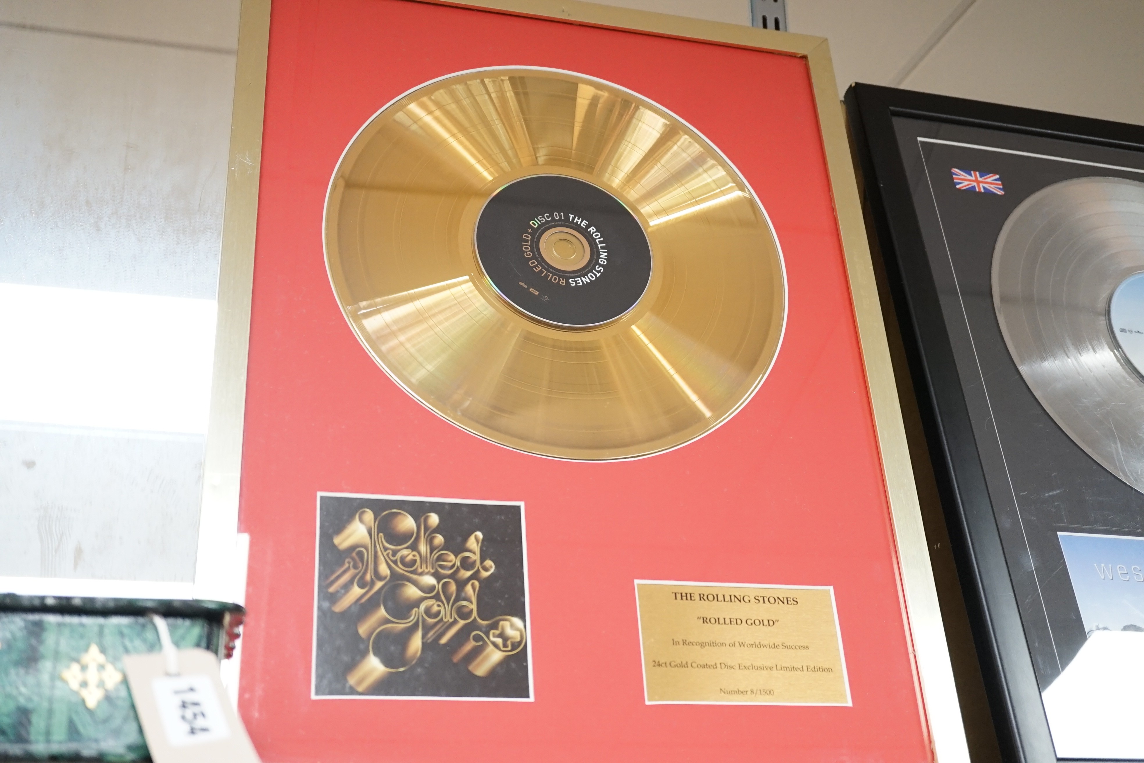 Three glazed framed award winning records: Pink Floyd, The Rolling Stones and Westlife